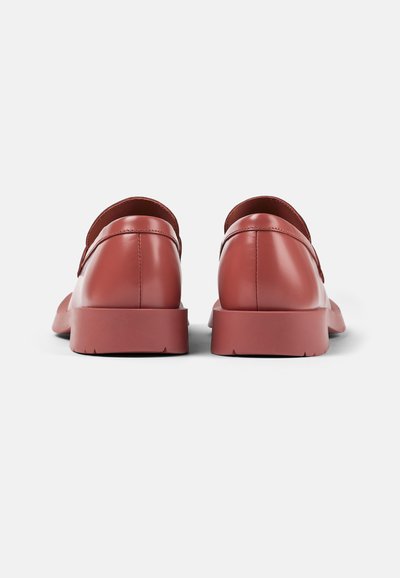 Red leather shoes with a smooth finish, rounded toe, and a low rubber sole. Back view shows a clean design and minimal accents.
