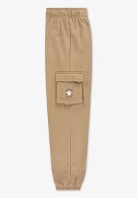 Beige joggebukser med elastisk midjebånd og mansjetter ved ankler. Har en sidelomme med klaff på siden og "Converse All Star"-logo.