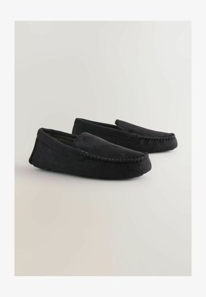 Schwarze Wildleder-Mokassins mit einer gestickten Akzentuierung um die Zehen und einem weichen Innenmuster. Flache Gummisohlen für guten Halt.