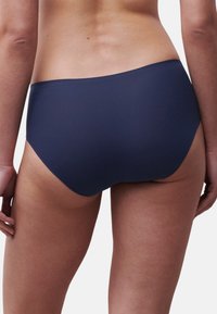 Marineblauwe bikinibroek met een glad, naadloos ontwerp. Het heeft een medium snit die volledige bedekking biedt met een subtiele elastische tailleband.