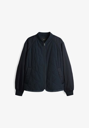 Navy quilted jacket with a bomber style, featuring a zip front, side pockets, ribbed collar and cuffs, and smooth fabric accents.