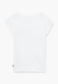 White cotton t-shirt with short sleeves, rounded neckline, and straight hem. Features a small red label at the side seam.