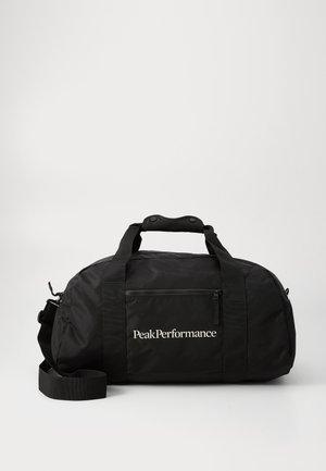 Black duffel bag made of nylon, featuring a zippered front pocket, dual handles, adjustable shoulder strap, and white "PeakPerformance" logo.