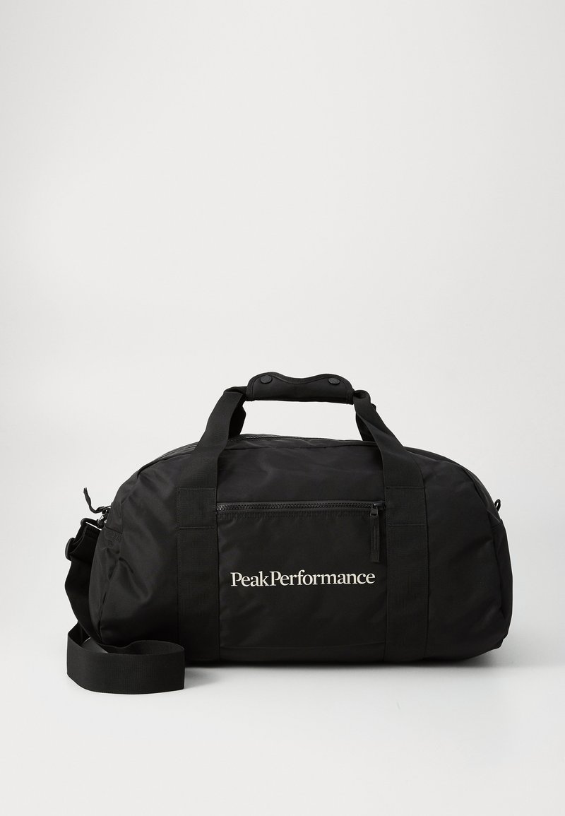Black duffel bag made of nylon, featuring a zippered front pocket, dual handles, adjustable shoulder strap, and white "PeakPerformance" logo.