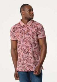 Korte mouw polo shirt in roze met een bladpatroon, met een contrasterende kraag en manchetten, gemaakt van ademend materiaal.