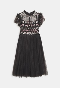 Robe midi noire avec corsage transparent brodé de fleurs, manches courtes à volants et jupe fluide en tulle avec un motif à pois subtil.
