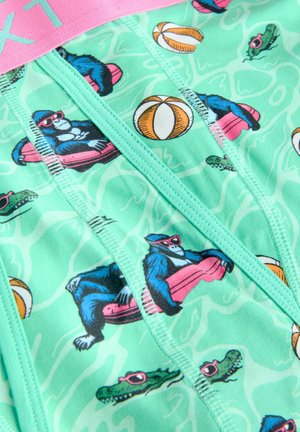 Kleurige zwembroek voor kinderen in mintgroene stof, versierd met cartoonapen, strandballen en krokodillen. Elastische tailleband in het roze.