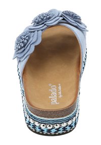 Light blue platform sandal with decorative fabric flowers, leather-like interior, woven details, and silver accents on the sole.