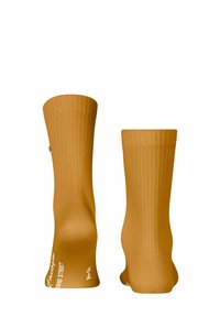 Calzini gialli a coste con una texture liscia, estremità arrotondate e dettagli testuali bianchi sulla parte inferiore. Design di lunghezza standard per calze alla caviglia.