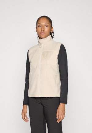 Beige fleece vest met hoge kraag en een patch pocket aan de voorkant. Voorzien van ritszakken aan de zijkant en een gestructureerde stof.
