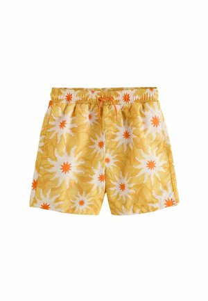 Kollased ujumispüksid valgete ja oranžide päikesekiirte mustritega ning oranži paelaga elastse vöökohaga.