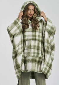 Groene en witte geruite oversized hoodie gemaakt van pluizig materiaal, met een voorzak en een capuchon met trekkoord. Zachte textuur en losse pasvorm.