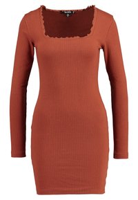 Robe à manches longues côtelée en terre cuite, avec un décolleté carré aux bords festonnés et une silhouette ajustée. Tissu doux et texturé.