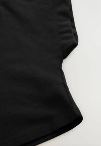 T-shirt en coton noir avec des manches courtes, un col rond et une texture lisse, avec des coutures visibles le long de l'ourlet.
