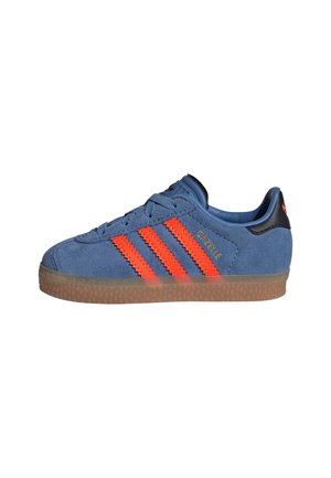 Baskets Adidas Gazelle en daim bleu avec des bandes orange et une semelle en gomme, vue de côté sur fond blanc.