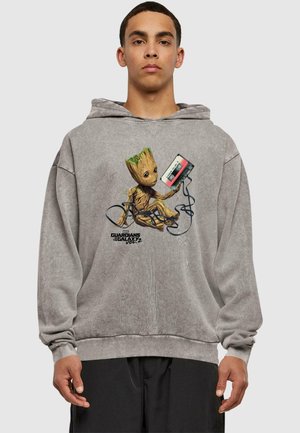 Gray hoodie made of cotton blend, features front graphic of a cartoon Groot holding a cassette tape with black cord. Classic fit.