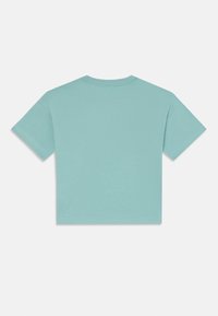 T-shirt court bleu clair en coton doux avec des manches courtes, un col rond et des coutures propres. Sans graphismes ni embellissements.