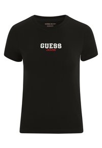 T-shirt en coton noir avec des manches courtes, un col rond et "GUESS JEANS" brodé en blanc et rouge sur le devant.
