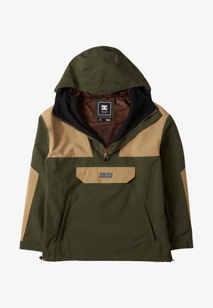 Green and tan anorak jacket with a hood, half-zip front, and a chest pocket. Features a logo and reinforced stitching. Waterproof material.