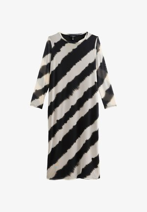 Vestido de manga larga en una tela ligera con un patrón de teñido anudado en negro y beige, con rayas diagonales y una silueta relajada.