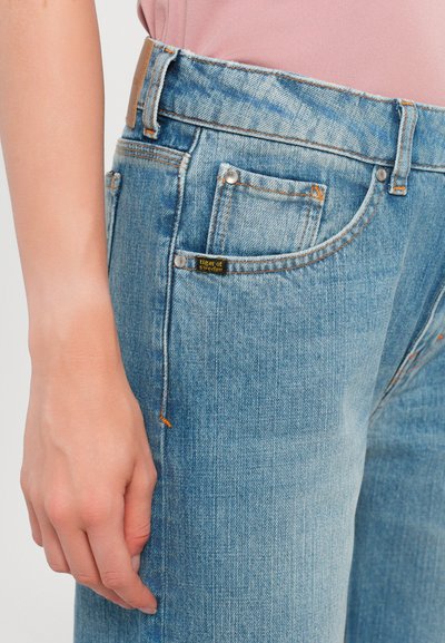 Light blue denim jeans with a high waist, featuring orange stitching, front pockets, and a label on the front pocket. Smooth texture.