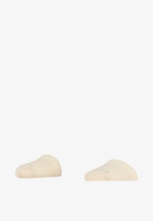 Chaussettes cheville beige en matériau doux et extensible, avec une texture lisse et un design bas, arborant un logo discret sur le côté.
