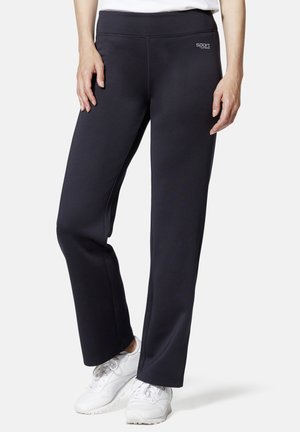 Black athletic pants with a smooth texture, high waistband, and subtle logo detail on the hip, paired with white sneakers.