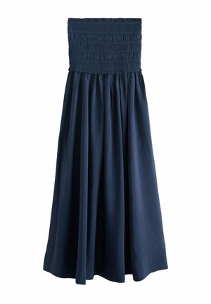 Strapless navy blue dress with smocked fitted bodice and flowing A-line skirt, made of lightweight fabric.