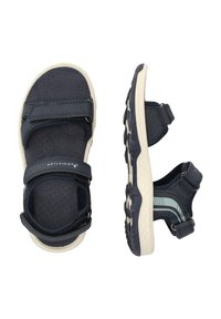 Marinblå justerbara sandaler med texturerad sula, kardborreband och vit gummisula med mönstrad slitbana för bra grepp.