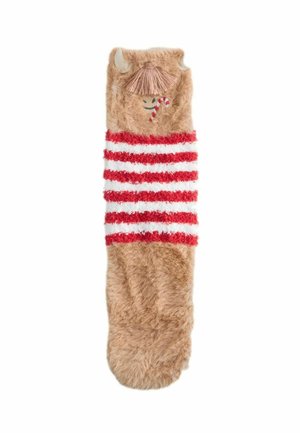 Furry brun strumpa med en röd och vit randig rem. Har ett ansikte, små horn och en tuft av tyg på toppen som liknar hår.