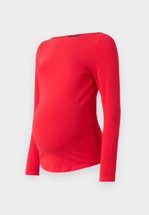 Červený těhotenský top s dlouhým rukávem a kulatým výstřihem. Vyrobený z měkké a elastické látky, navržený tak, aby vyhovoval rostoucímu bříšku.