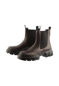 Bruine leren Chelsea-boots met elastische zijpanelen, dikke zwarte rubberen zool en lusjes voor gemakkelijk aan- en uittrekken. Glad oppervlak.
