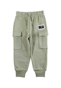 Pantalon de survêtement vert clair avec une taille élastique, des chevilles resserrées, deux poches cargo sur les côtés et une étiquette en tissu. Matière douce et texturée.