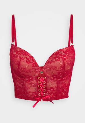Reggiseno di pizzo rosso con coppe strutturate, spalline regolabili e un decorativo laccio frontale con hardware dorato e nastri di raso rosa.