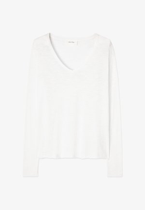 Valge pikkade varrukatega V-kaelusega kerge kampsun, millel on veidi lahtine lõige ja sirge alumine äär.