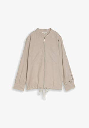 Veste beige à manches longues avec fermeture éclair frontale, deux poches poitrine, poignets froncés et ourlet réglable à cordon de serrage.