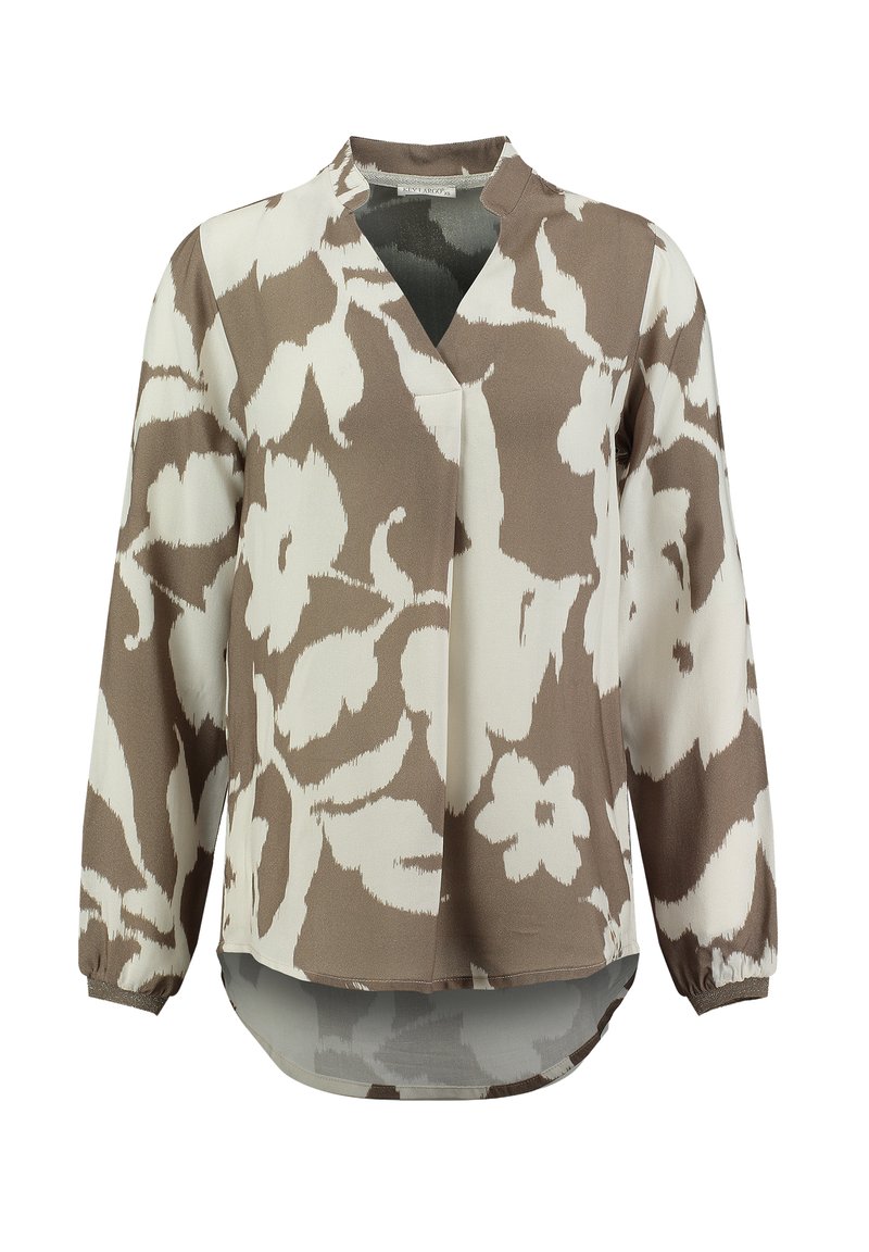 Blusa a maniche lunghe con motivo floreale marrone e crema, vestibilità rilassata con scollatura a V, polsini arricciati e orlo posteriore più lungo. Tessuto morbido e liscio.