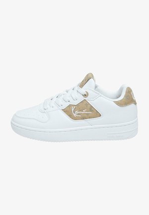 Valged tenniset jalatsid, millel on külgedel tekstuuriga beež aktsent, ümar varvas ja lamedat kummist tallad. Ka paelad ja logo on valged.