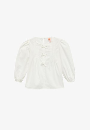 Blusa blanca con mangas abullonadas, cierres de botón con lazo, detalles plisados en la parte delantera y escote redondo. Material de algodón suave.