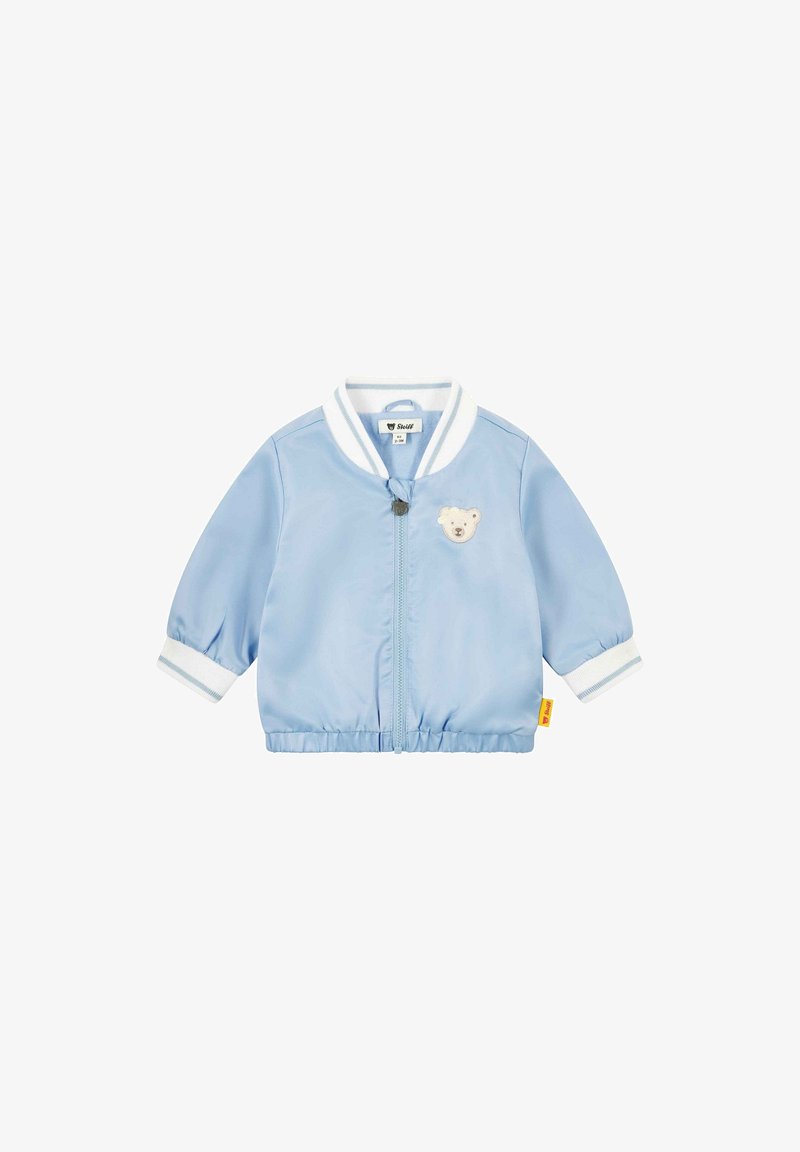 Veste bébé bleu clair avec col et poignets à rayures blanches, fermeture éclair à l'avant, et une petite écusson en forme d'ourson sur la poitrine.