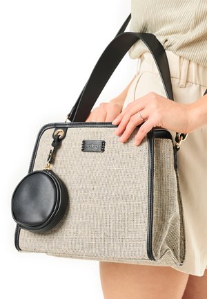 Beige woven bag with black leather accents, rectangular shape, and dual handles. Features a detachable round black pouch attached with hardware.