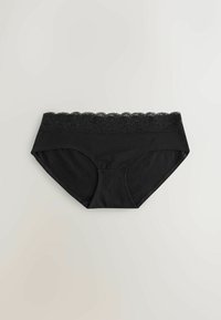 Culottes hipster pour femmes noires avec détail en dentelle à la taille, posées à plat sur un fond gris clair.