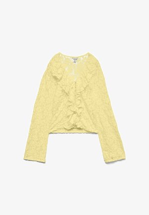 Gelbe langärmelige Spitzenbluse mit V-Ausschnitt und Rüschendetail entlang der Vordermitte.