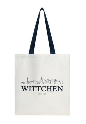 White tote bag with black handles, featuring a black city skyline above the brand name "WITTCHEN" and "since 1990" text below.
