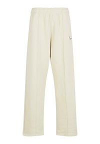 Pantaloni de sport crem cu o croială relaxată, talie elastică și detalii de cusătură subtile. Prezintă un mic logo brodat.