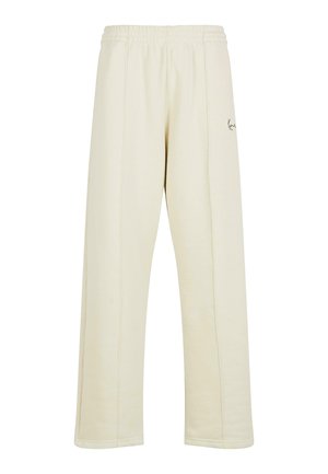 Cream-colored sweatpants with a relaxed fit, elasticated waistband, and subtle stitching details. Features a small embroidered logo.