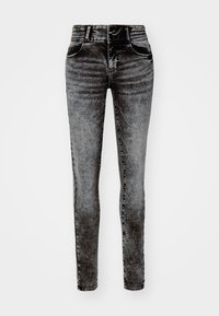Jean skinny en denim noir délavé, présentant une taille haute, une ceinture côtelée, deux poches avant et des détails de couture discrets.