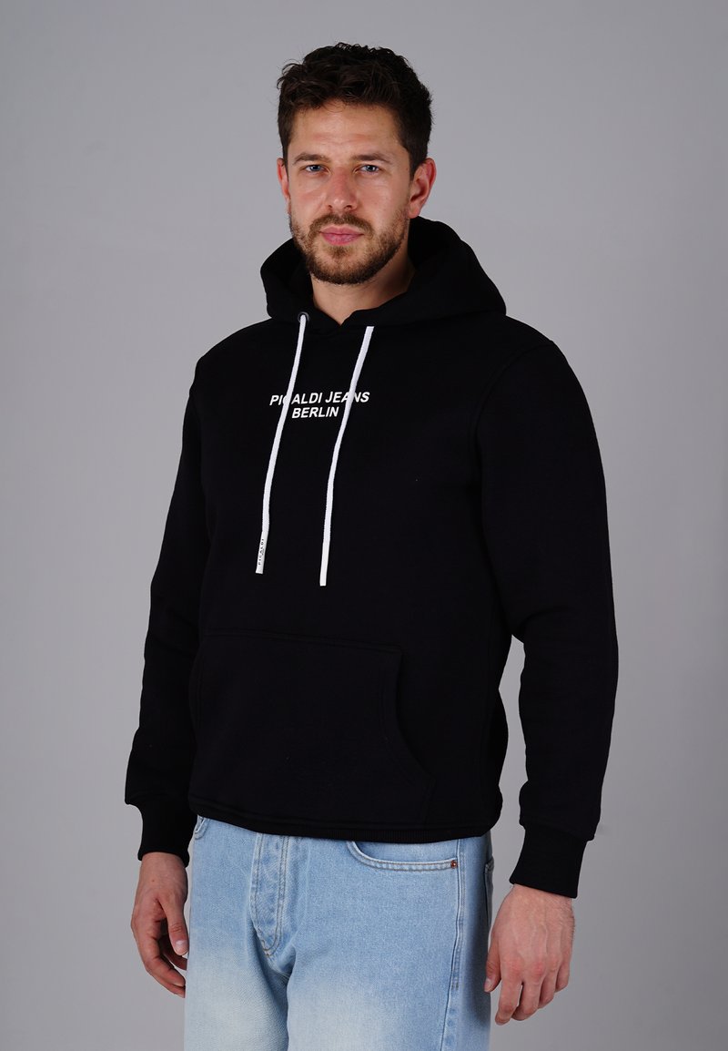 Black hoodie with white drawstrings and kangaroo pocket, featuring "PRAALDI JEANS BERLIN" text in the center. Material appears soft and textured.