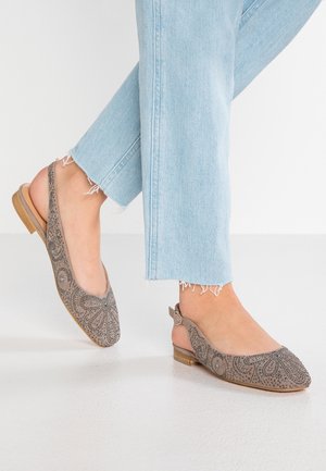 Gray slingback flats with decorative silver bead patterns, rounded toe, and a small wooden heel, paired with light blue frayed jeans.