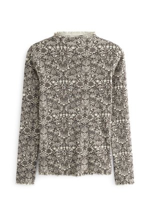Pitkähihainen paita, jossa on korkea pääntie ja monimutkainen mustavalkoinen kukka- ja köynnöskuvio vaalealla pohjalla.